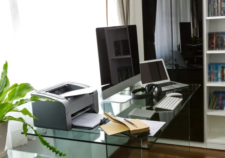 Modern home office with computer and laptop